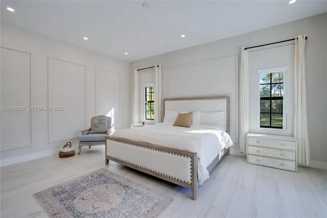 a bedroom with a bed furniture and a window