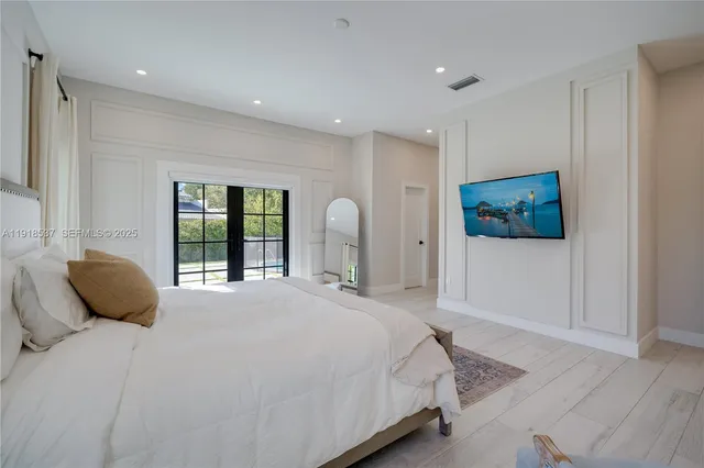 a bathroom with a granite countertop sink vanity mirror bathtub shower and toilet