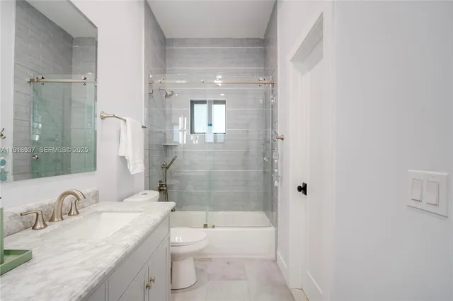 a living room with a floor to ceiling window and a rug
