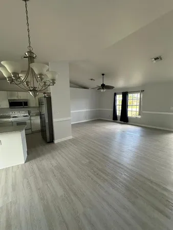 a view of a kitchen with a sink and dishwasher wooden floor