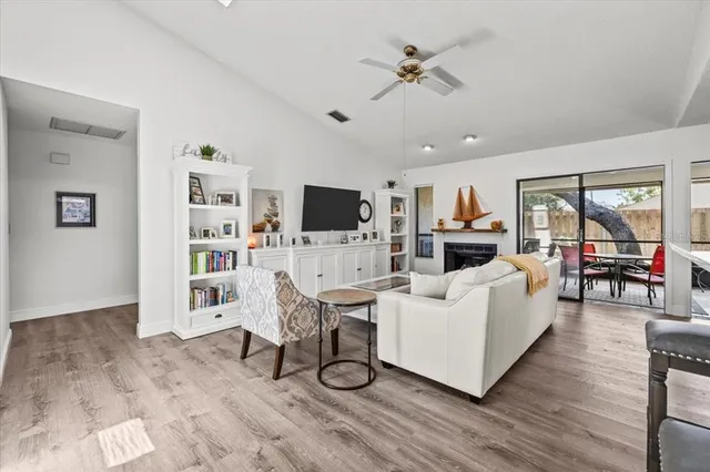 a dining room with furniture a chandelier and wooden floor