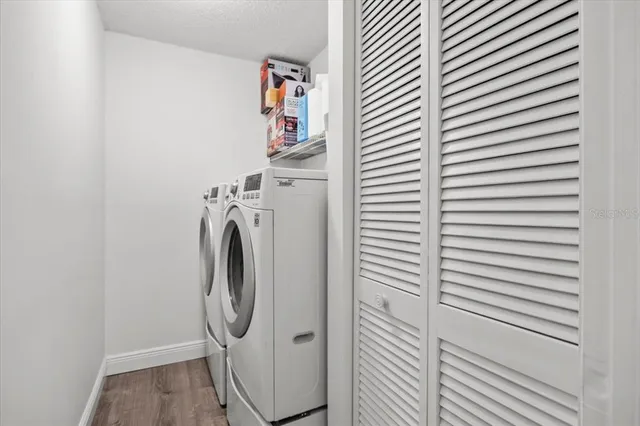 a bedroom with a bed a mirror and a large window