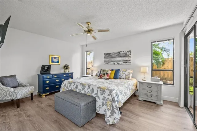 a bedroom with a bed a chandelier and a window
