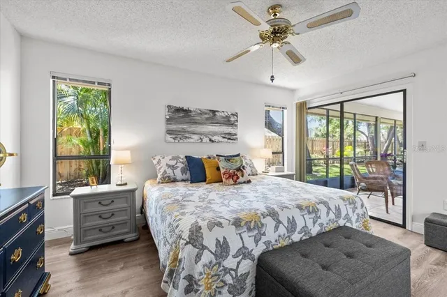 a bedroom with a bed and a ceiling fan