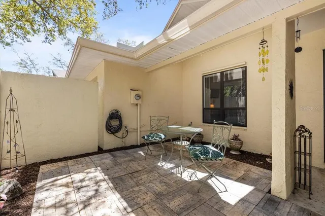 a backyard of a house with yard and outdoor seating