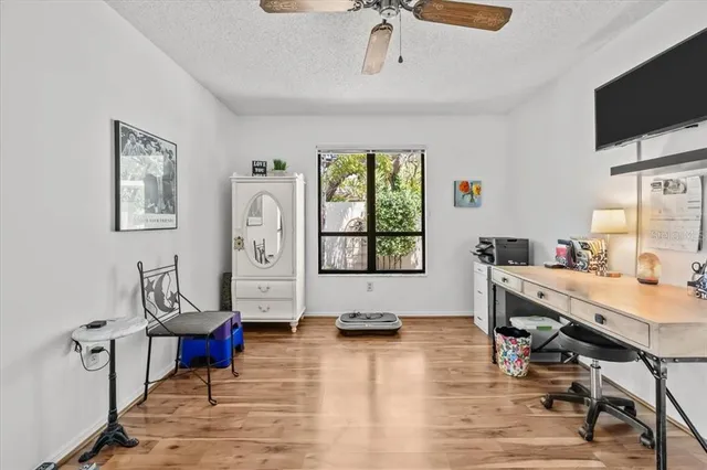 a view of a workspace with furniture window and wooden floor