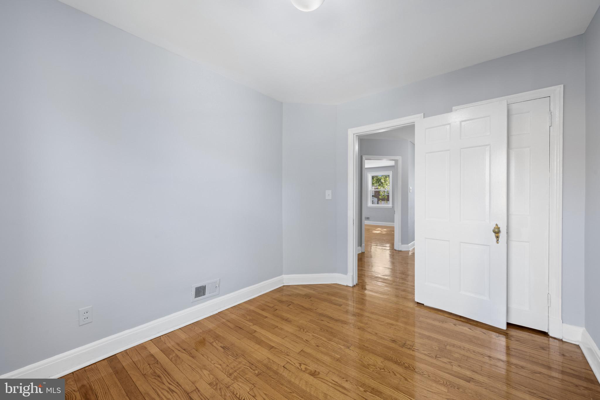 1516 East 36th Street Baltimore, MD 21218 - Photo 20 of 33 a view of an empty room with wooden floor