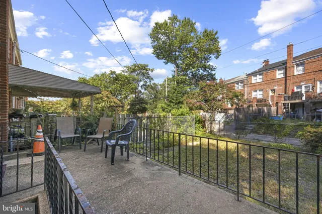 a view of a chairs and table in patio with a yard