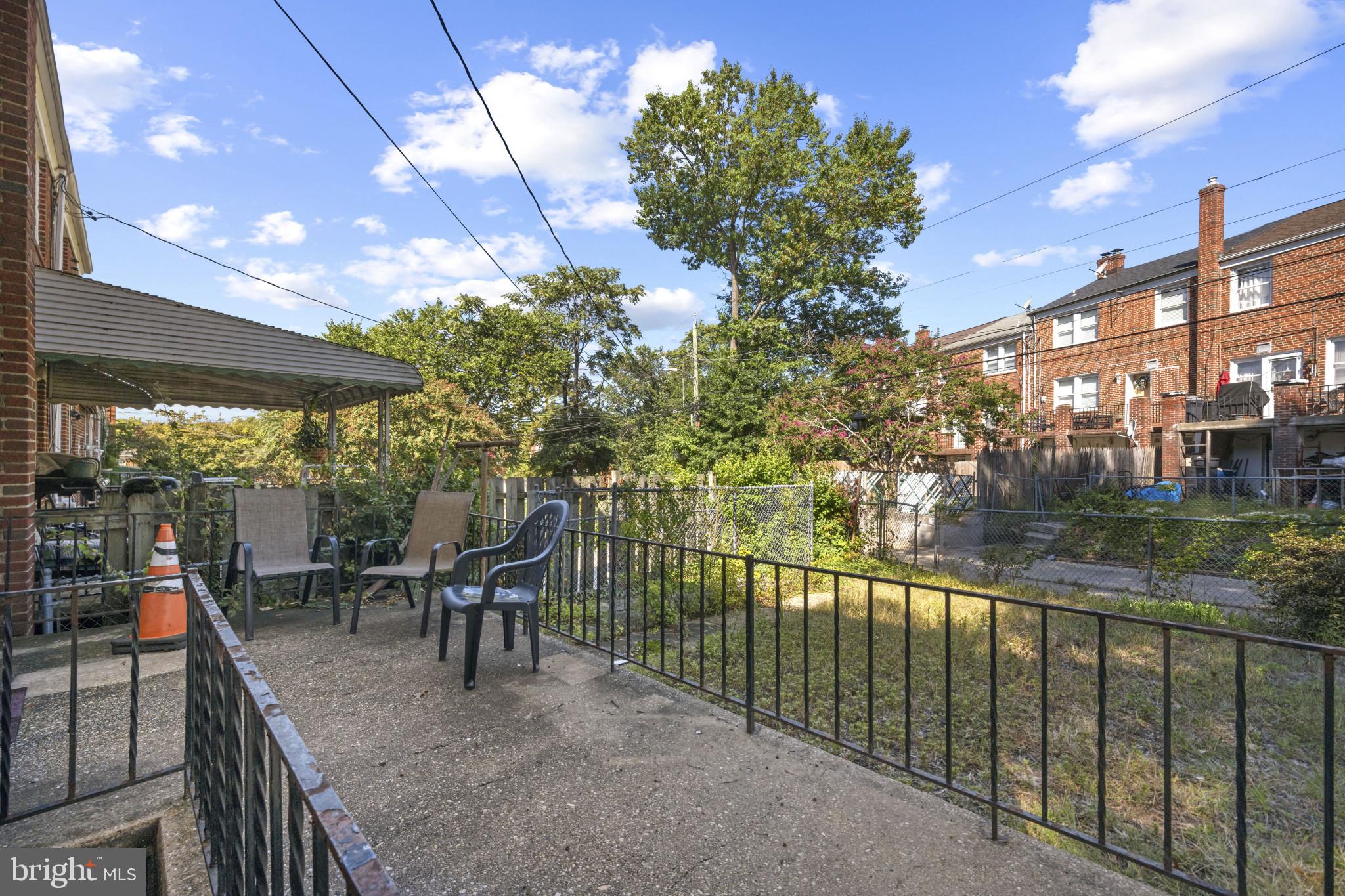 1516 East 36th Street Baltimore, MD 21218 - Photo 27 of 33 a view of a chairs and table in patio with a yard