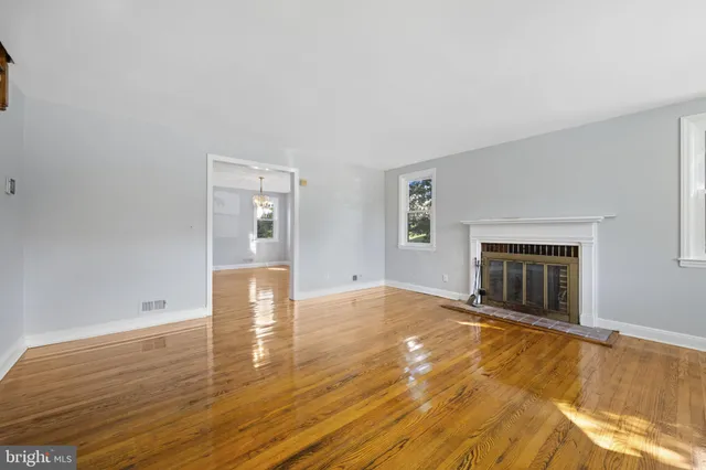 wooden floor in an empty room with a fireplace