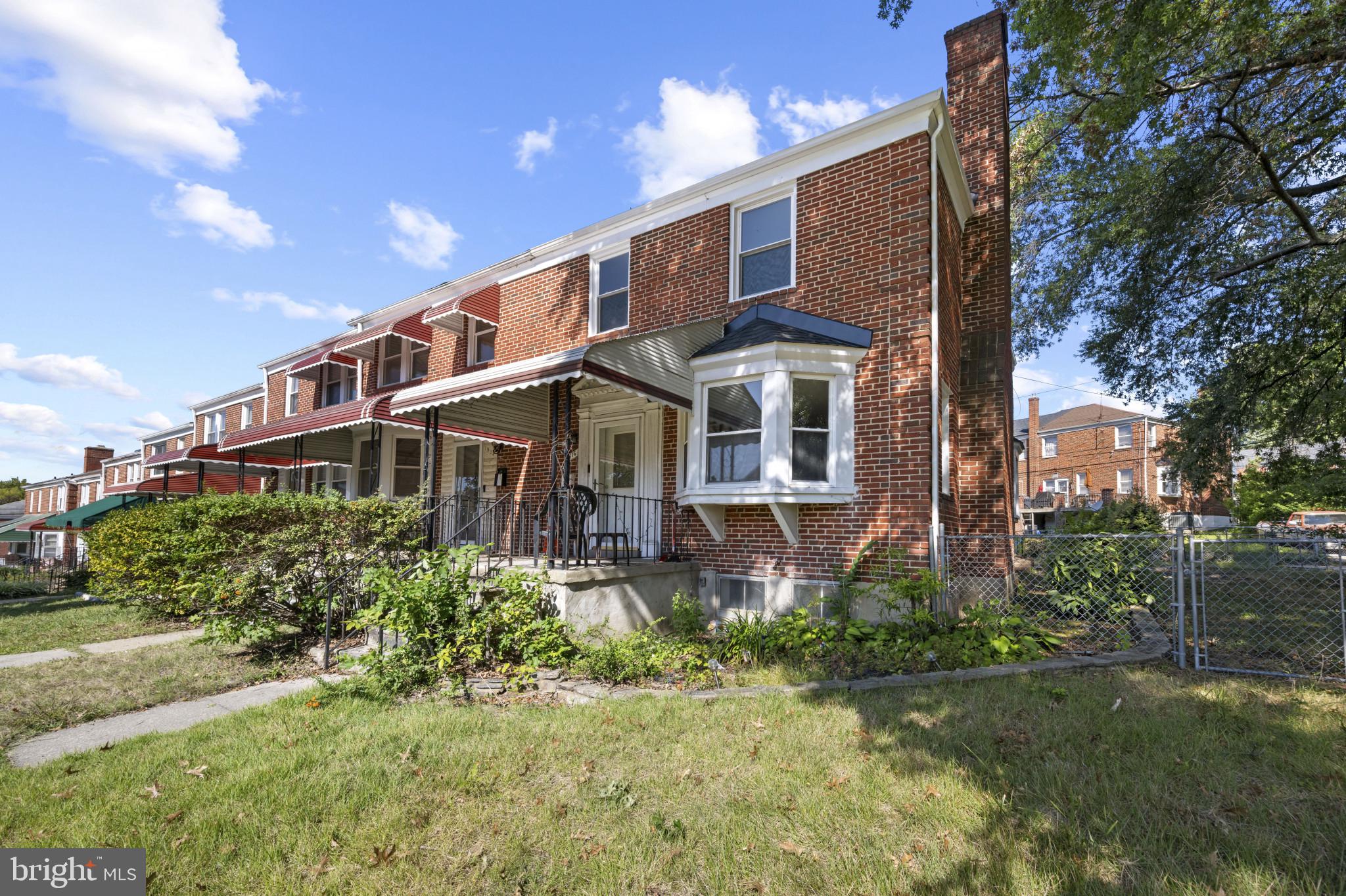 1516 East 36th Street Baltimore, MD 21218 - Photo 32 of 33 a front view of a house with a yard