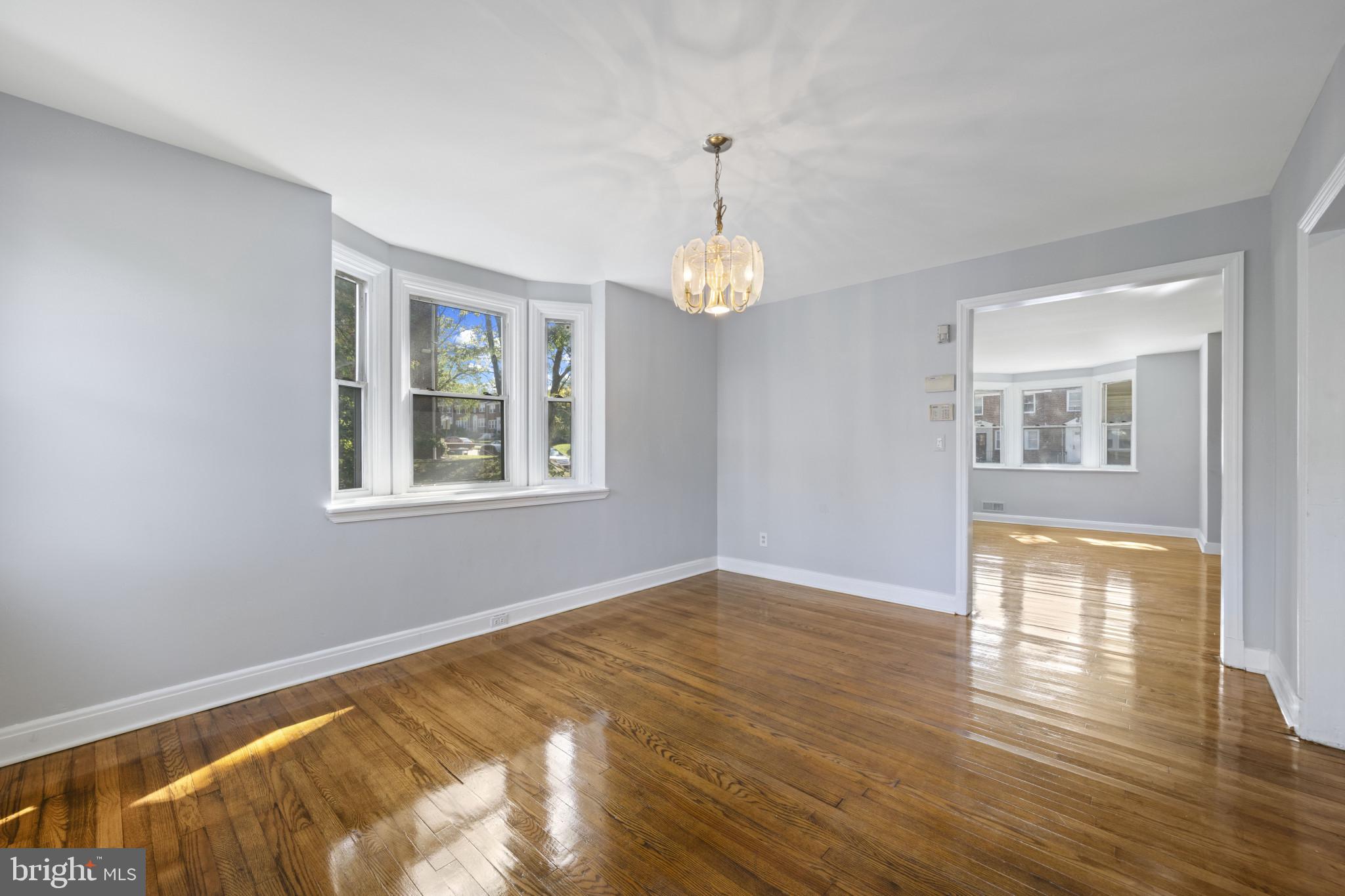 1516 East 36th Street Baltimore, MD 21218 - Photo 9 of 33 a view of an empty room with wooden floor and a window