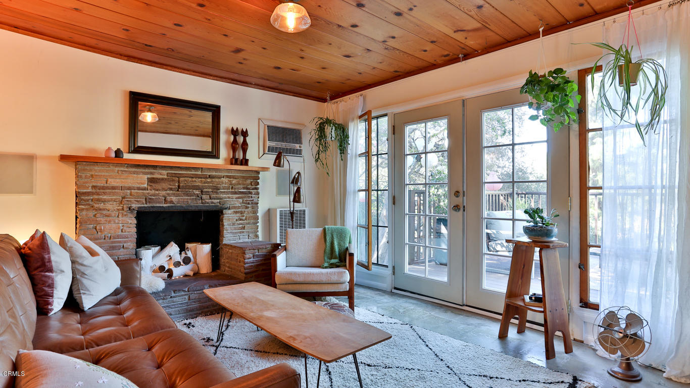 9525 Reverie Road Tujunga, CA 91042 - Photo 2 of 47 a living room with furniture a large window and a fireplace
