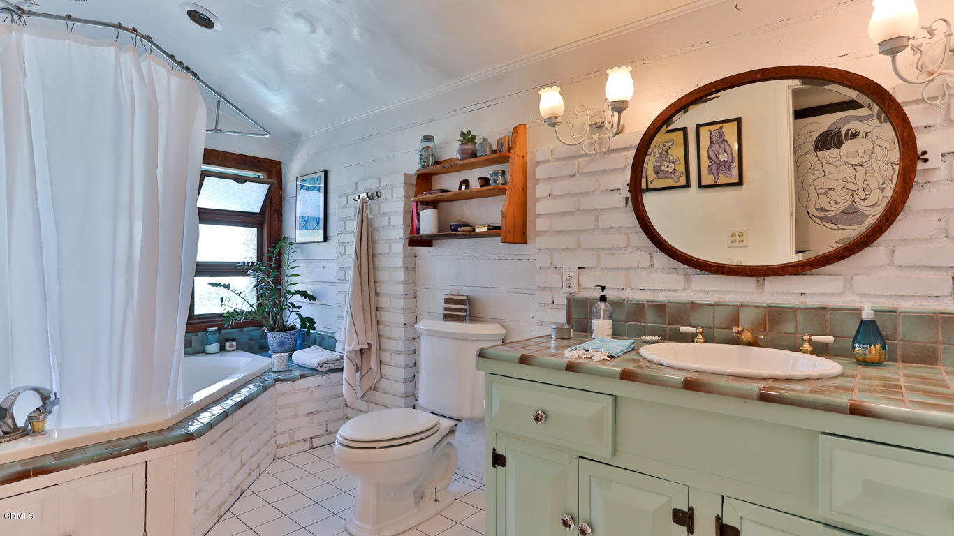 9525 Reverie Road Tujunga, CA 91042 - Photo 24 of 47 a bathroom with a toilet a sink and mirror