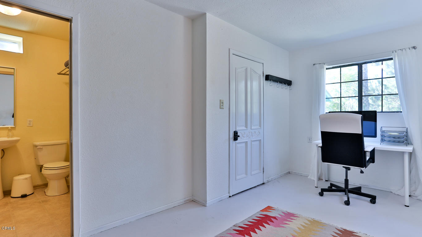 9525 Reverie Road Tujunga, CA 91042 - Photo 29 of 47 a view of a workspace with furniture and a window