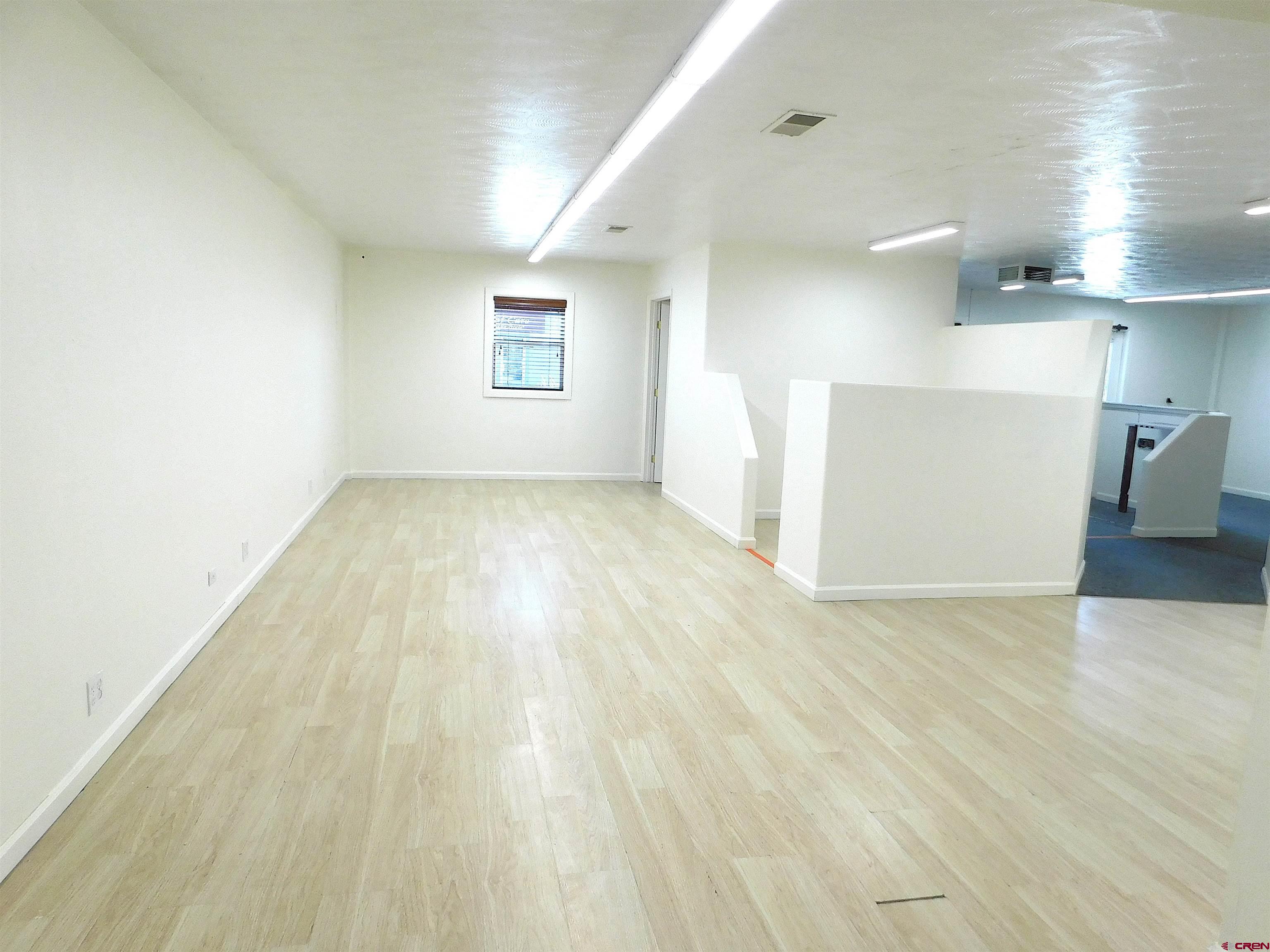 151 West 2nd Street Delta, CO 81416 - Photo 17 of 33 an empty room with wooden floor and windows