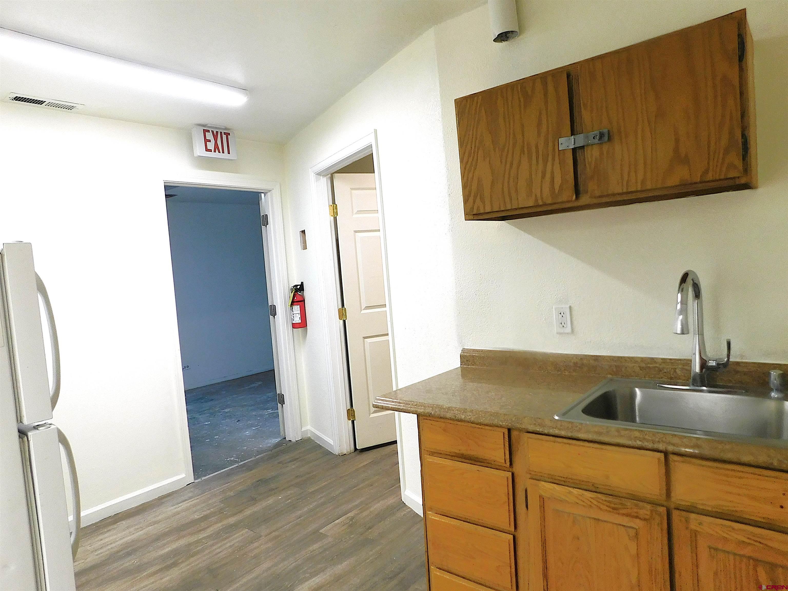 151 West 2nd Street Delta, CO 81416 - Photo 22 of 33 a kitchen with a sink and a refrigerator