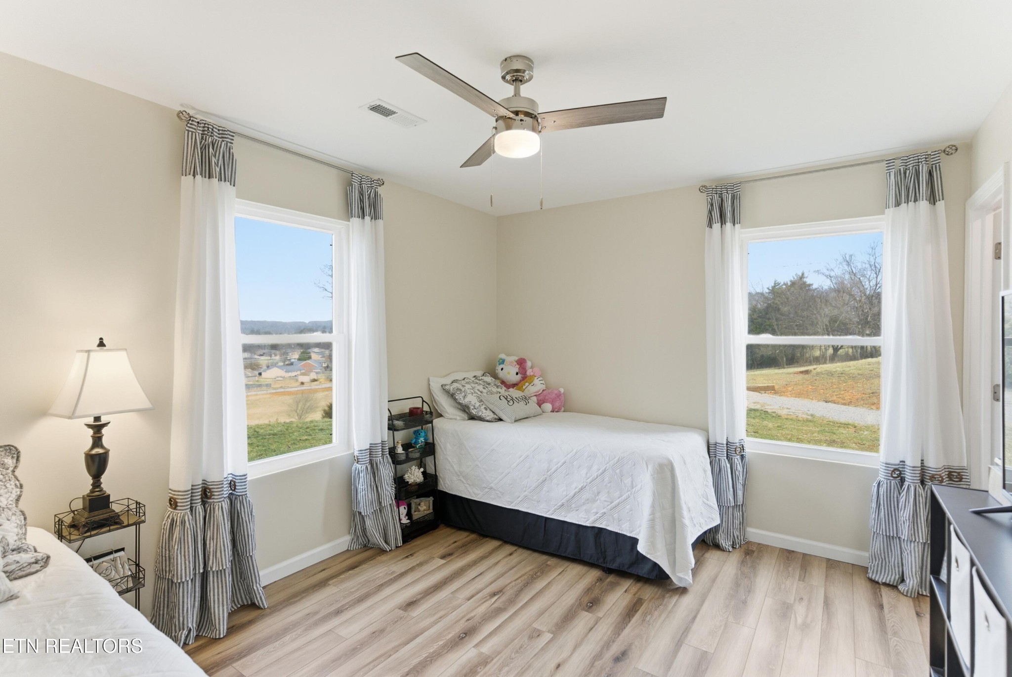6911 Fairview Road Corryton, TN 37721 - Photo 16 of 30 a bedroom with a bed and a large window with wooden floor