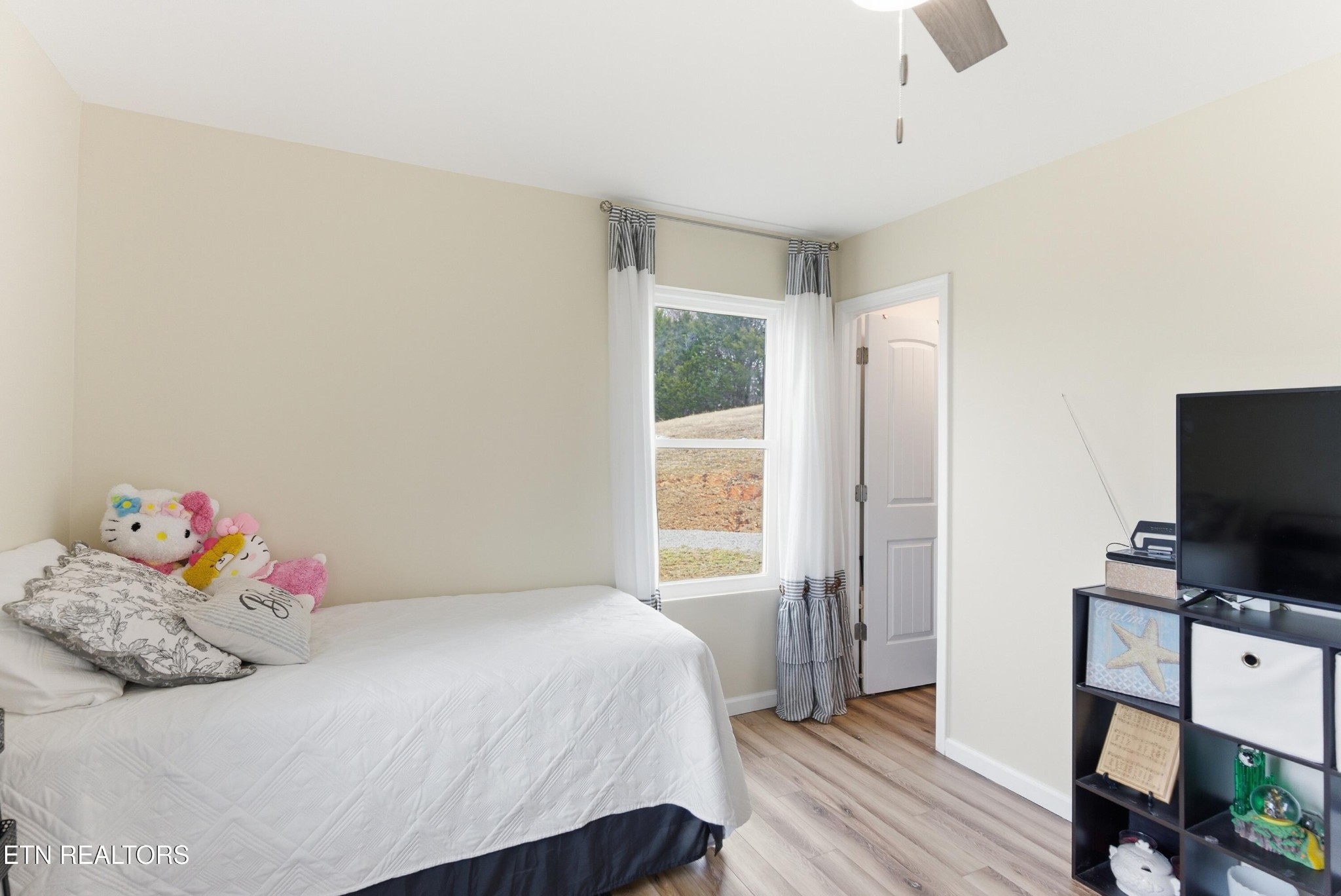 6911 Fairview Road Corryton, TN 37721 - Photo 18 of 30 a bedroom with a bed and a flat screen tv