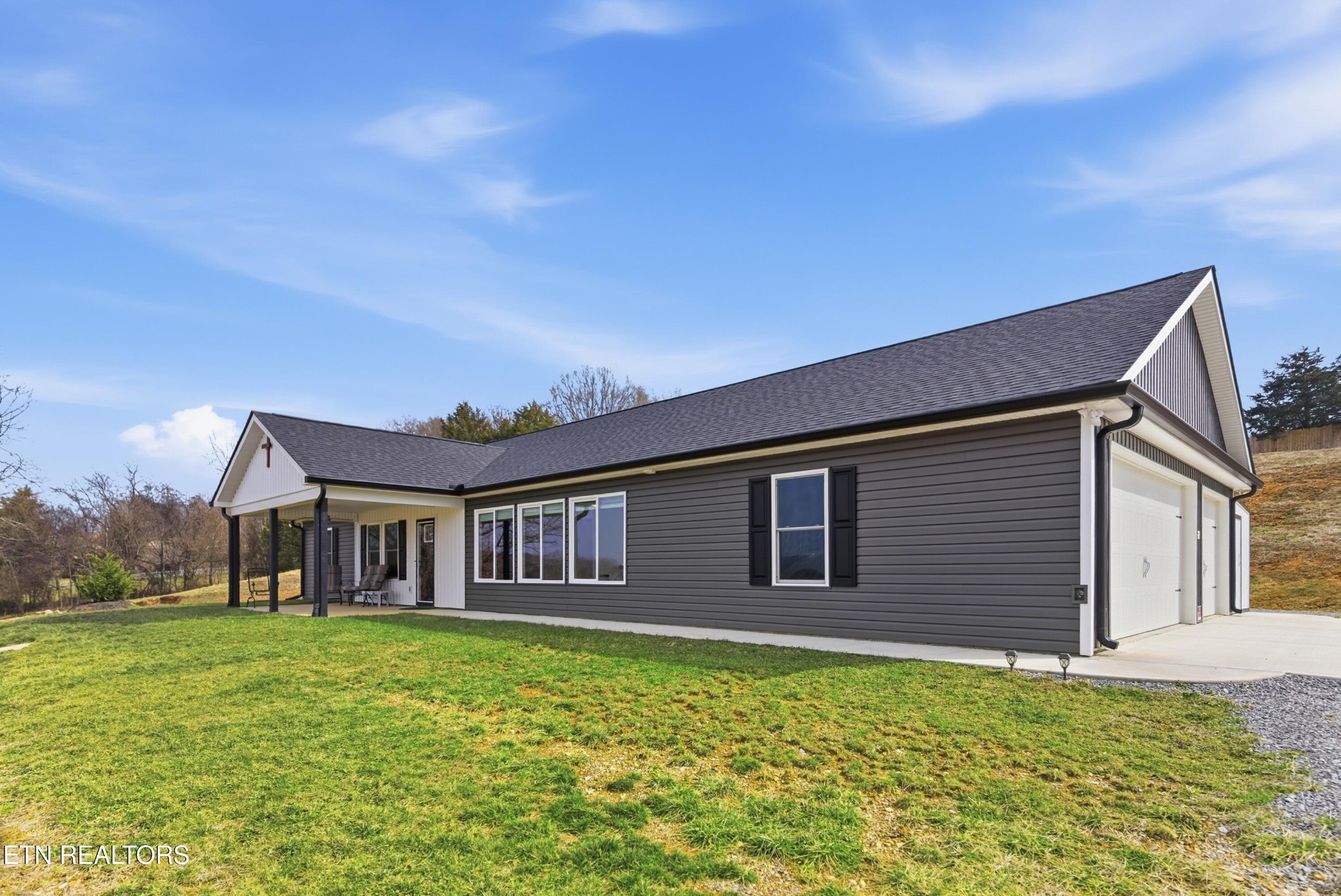 6911 Fairview Road Corryton, TN 37721 - Photo 2 of 30 a front view of a house with garden
