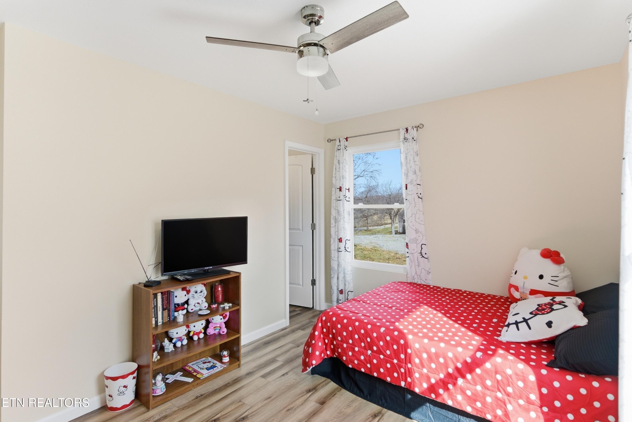 6911 Fairview Road Corryton, TN 37721 - Photo 21 of 30 a bedroom with a bed and a flat screen tv