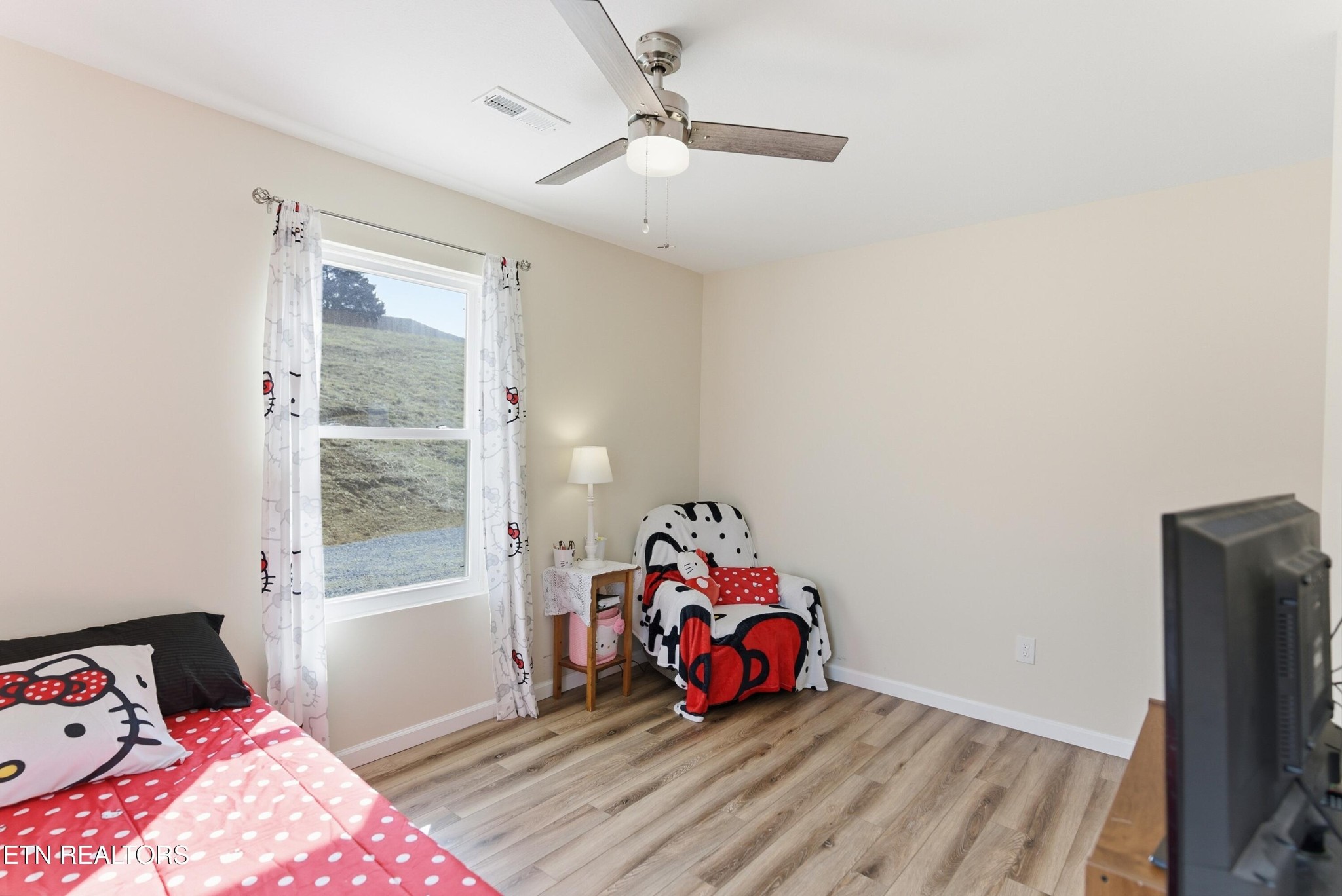 6911 Fairview Road Corryton, TN 37721 - Photo 22 of 30 a bedroom with a bed and wooden floor
