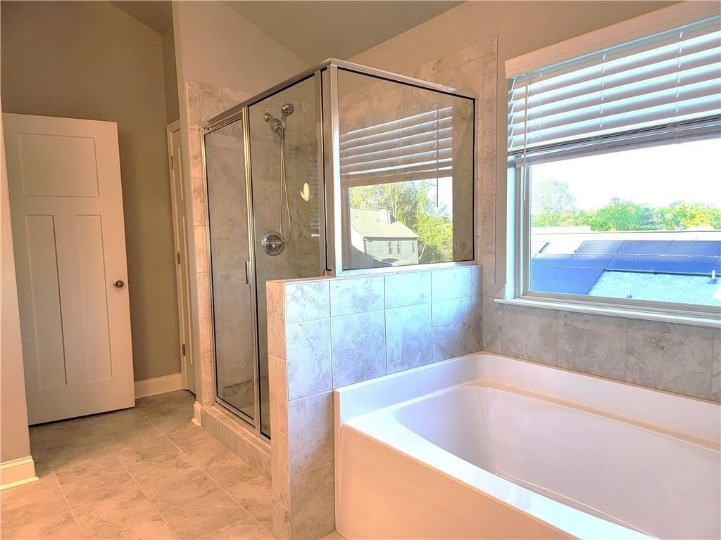 1866 Castleberry Drive Buford, GA 30518 - Photo 11 of 11 a bathroom with a tub and shower