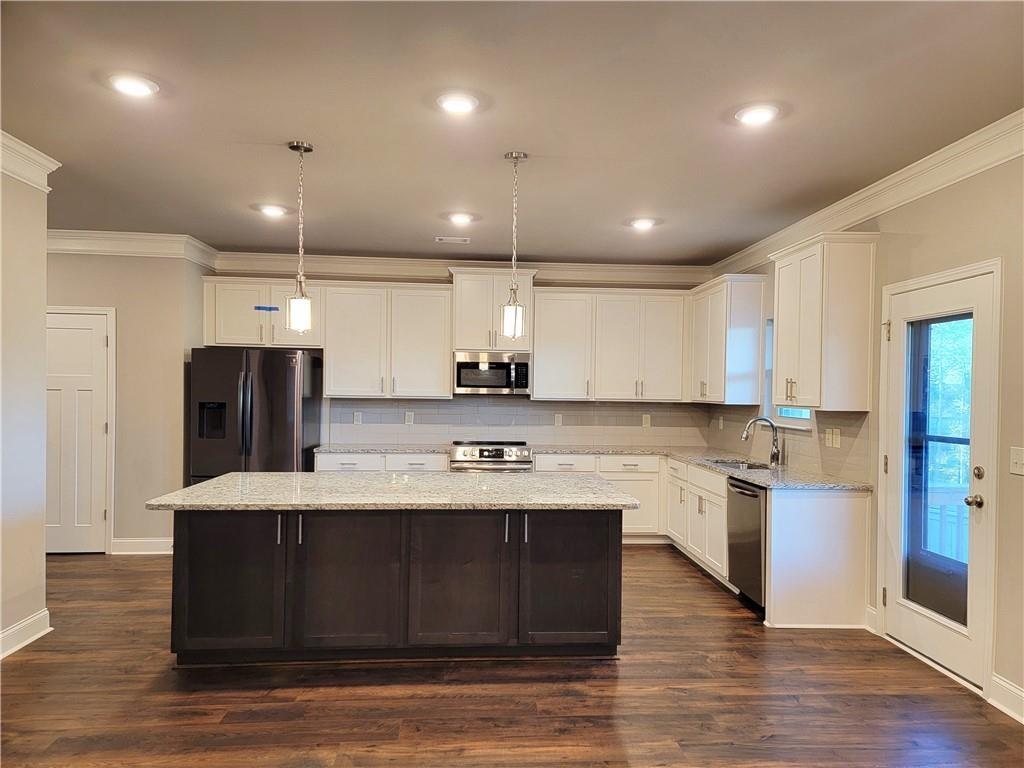1866 Castleberry Drive Buford, GA 30518 - Photo 4 of 11 a large kitchen with stainless steel appliances kitchen island a large island in the center