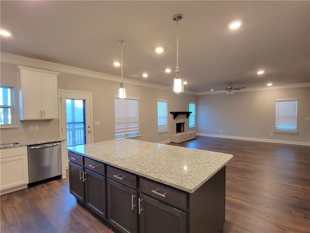 1866 Castleberry Drive Buford, GA 30518 - Photo 7 of 11 an open kitchen with kitchen island a sink dishwasher a stove and a refrigerator with wooden floor