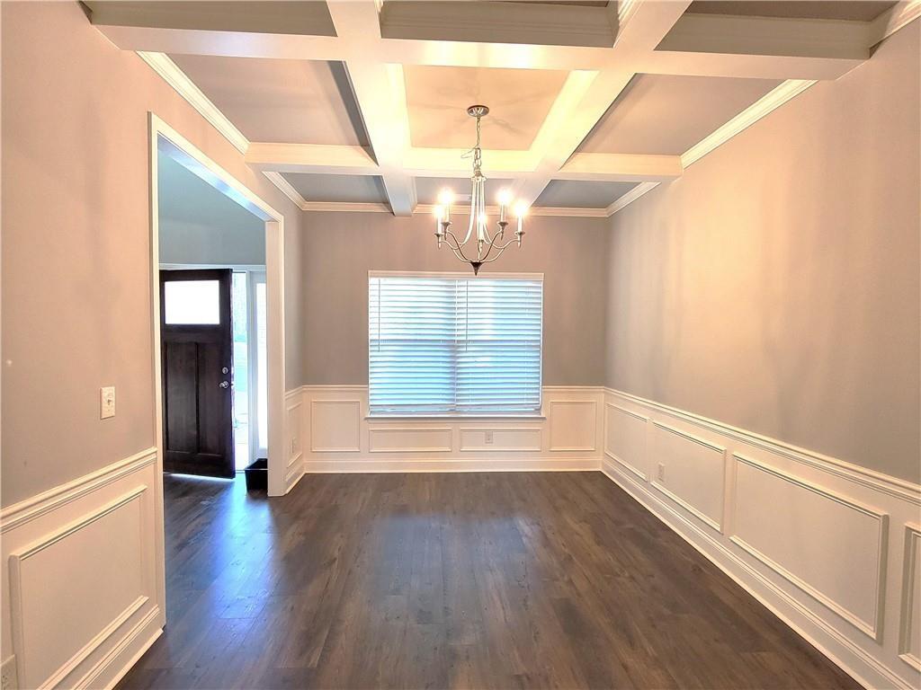 1866 Castleberry Drive Buford, GA 30518 - Photo 9 of 11 a view of a room with wooden floors and chandelier