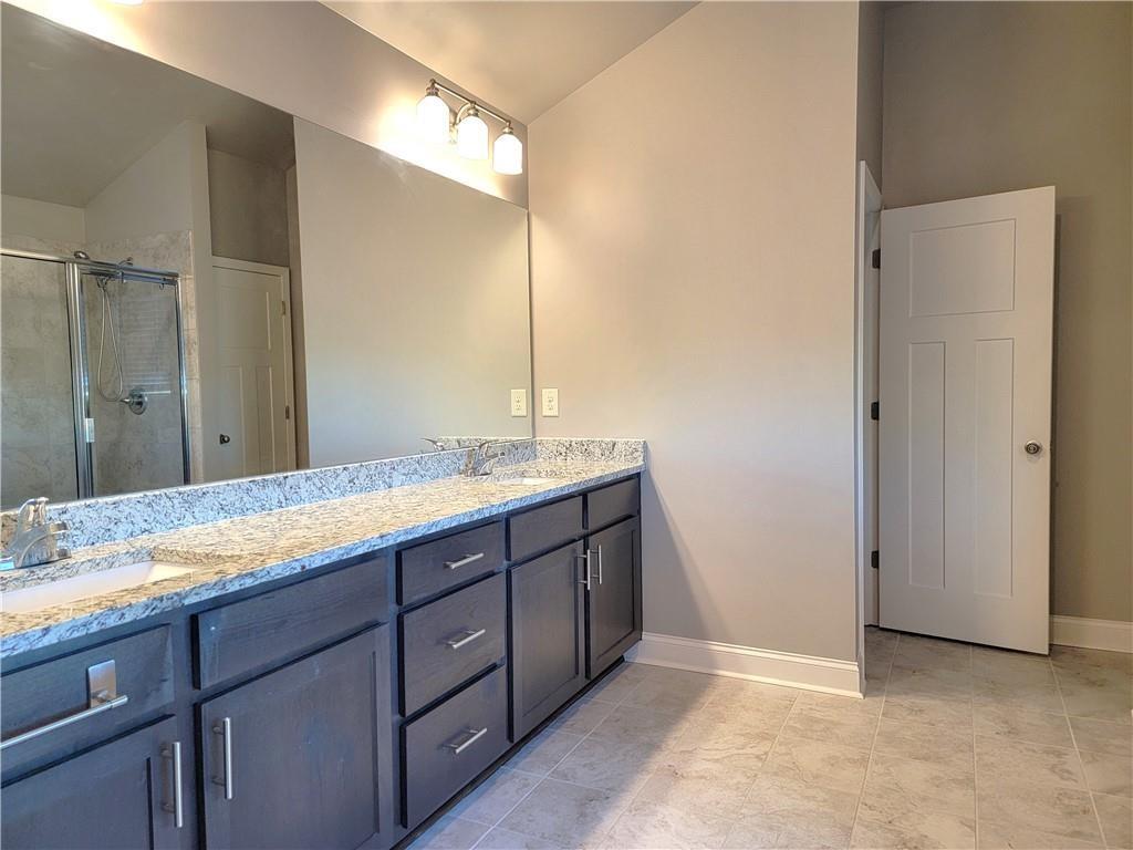 1866 Castleberry Drive Buford, GA 30518 - Photo 10 of 11 a bathroom with a sink and a mirror