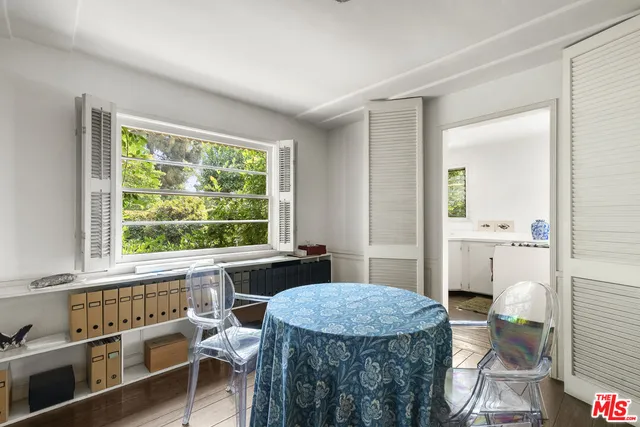 a kitchen with a table chairs and a window