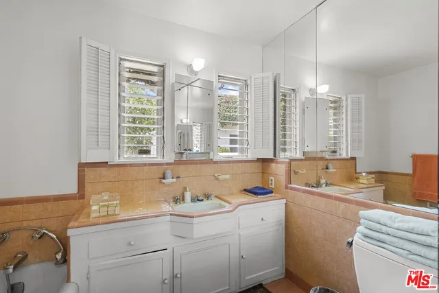 a bathroom with a granite countertop sink and a bathtub