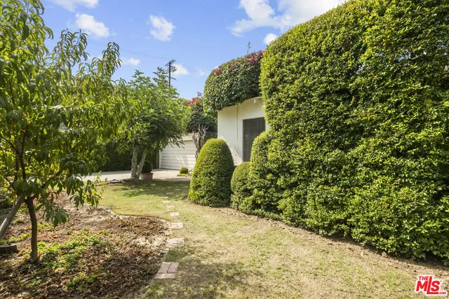 a backyard of a house with a yard and garage
