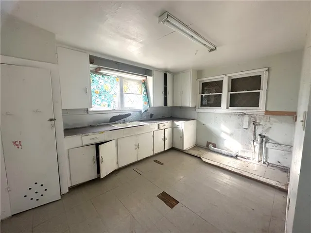 a kitchen with granite countertop a sink stainless steel appliances and cabinets