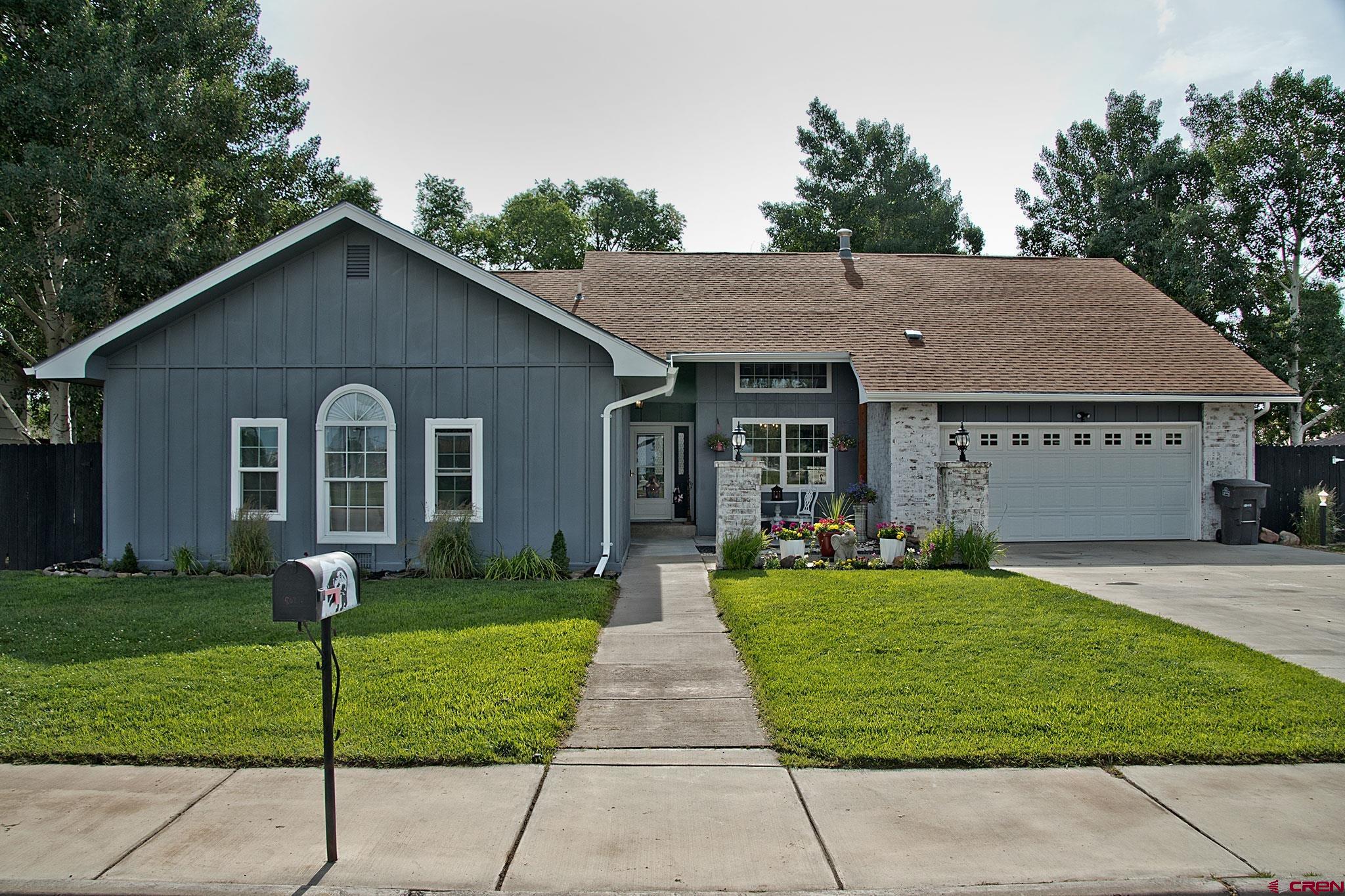 808 Weber Drive Alamosa, CO 81101 - Photo 1 of 44 a front view of a house with a yard