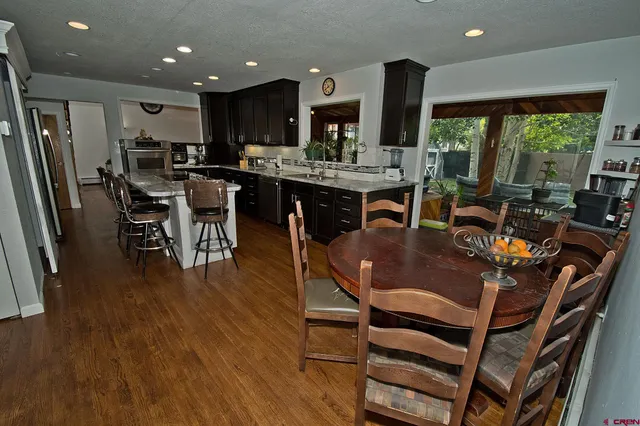 a view of a dining room with furniture window and wooden floor