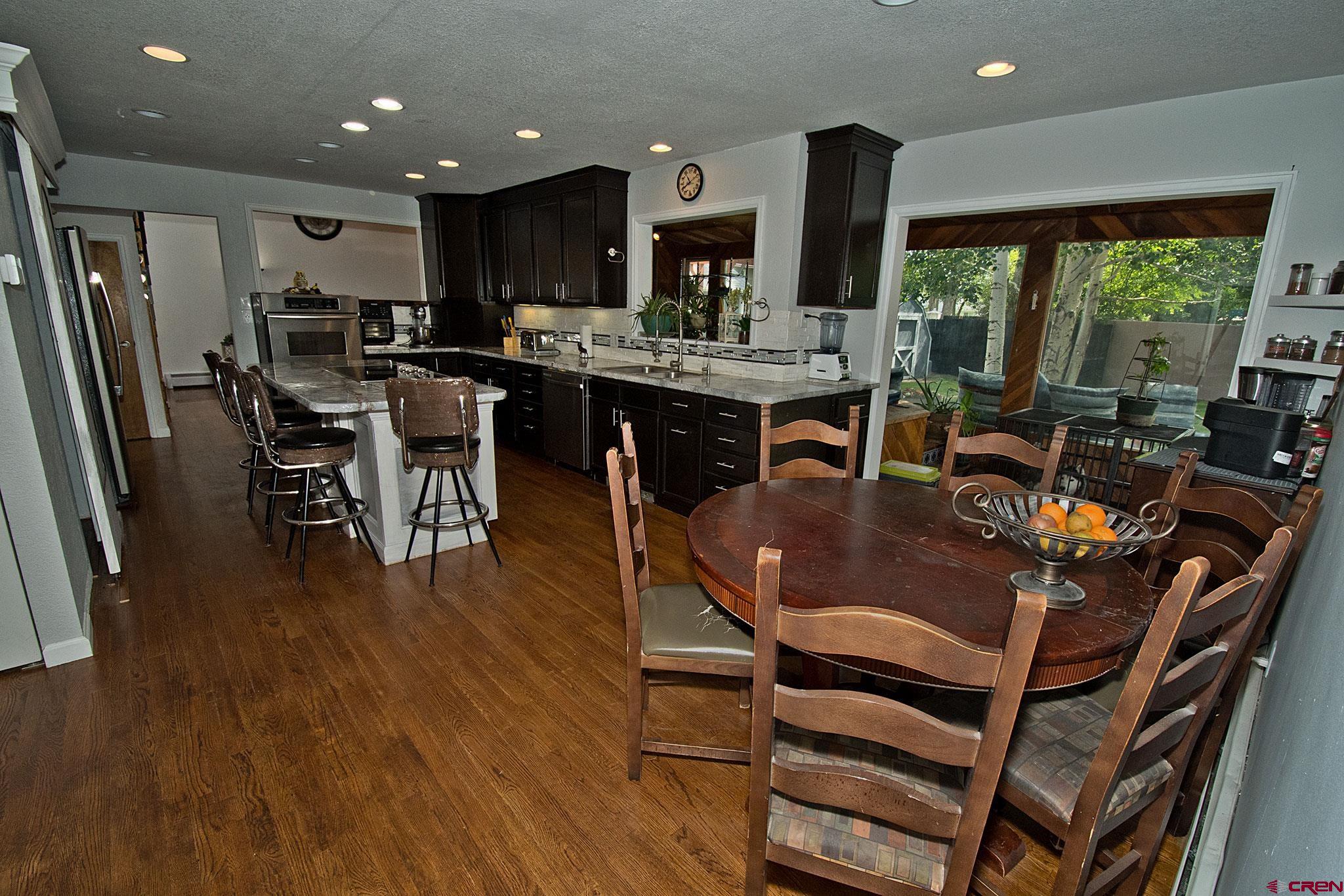 808 Weber Drive Alamosa, CO 81101 - Photo 12 of 44 a view of a dining room with furniture window and wooden floor