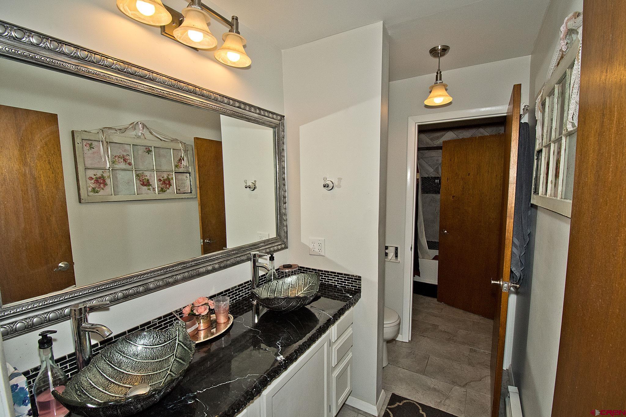 808 Weber Drive Alamosa, CO 81101 - Photo 20 of 44 a kitchen with a stove and a refrigerator