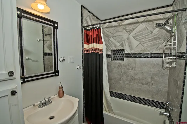 a bathroom with a shower and a sink