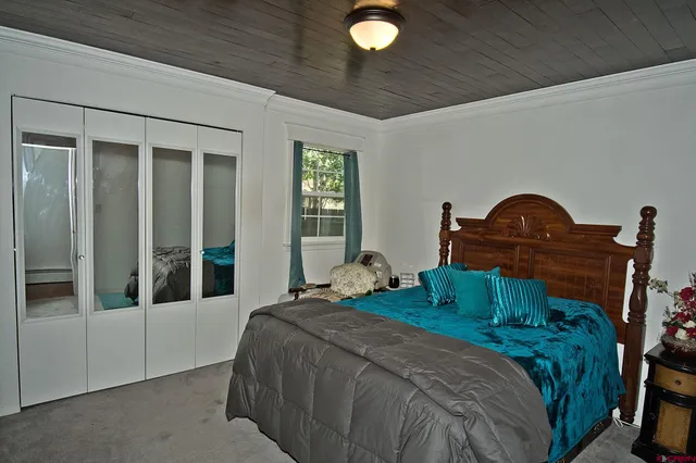 a bedroom with a bed and a mirror