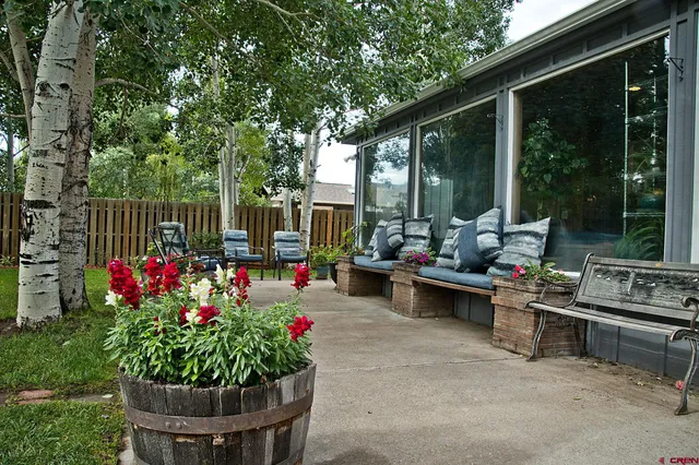 a view of a house with backyard porch and sitting area