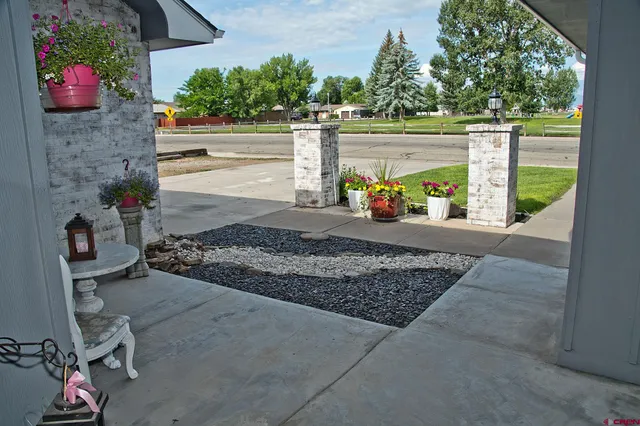 a view of a garden with wooden bench