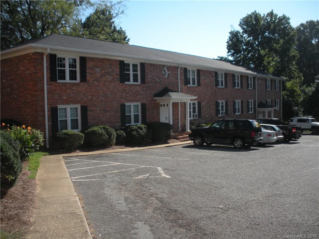 a view of multiple house with cars parked in front of house