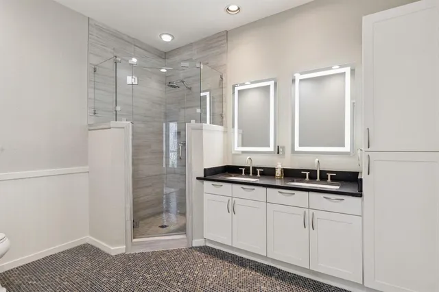 a bathroom with a double vanity sink and mirror
