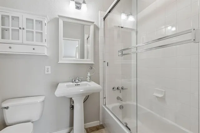 a view of a balcony with wooden floor and fence