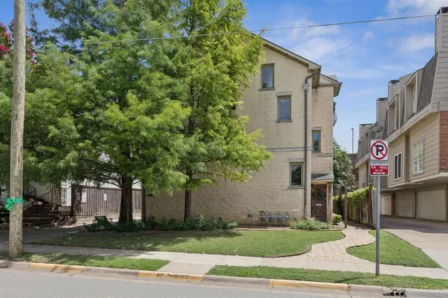 a street sign on a sidewalk next to a road