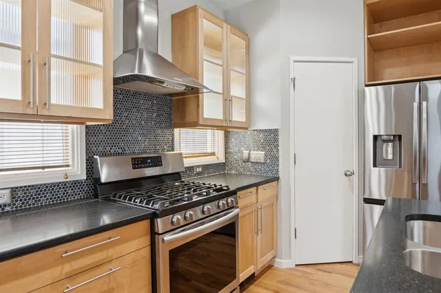 a kitchen with stainless steel appliances granite countertop a stove and a refrigerator