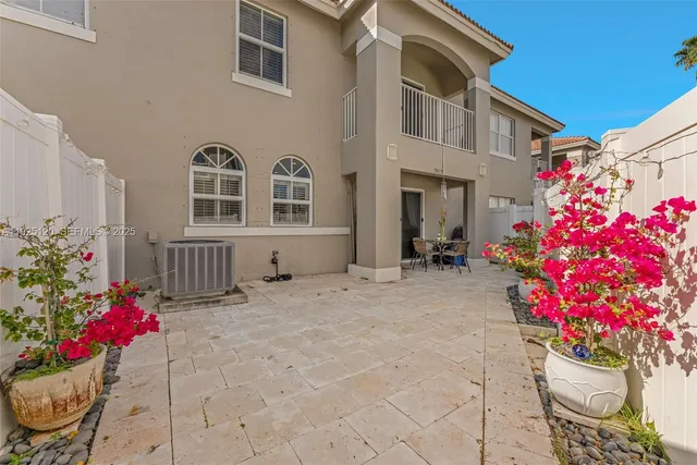 a view of a house with a yard and a potted plant
