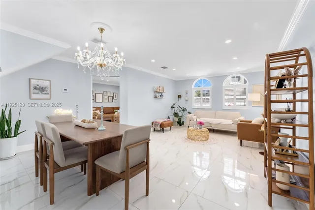 a view of a dining room with furniture and chandelier